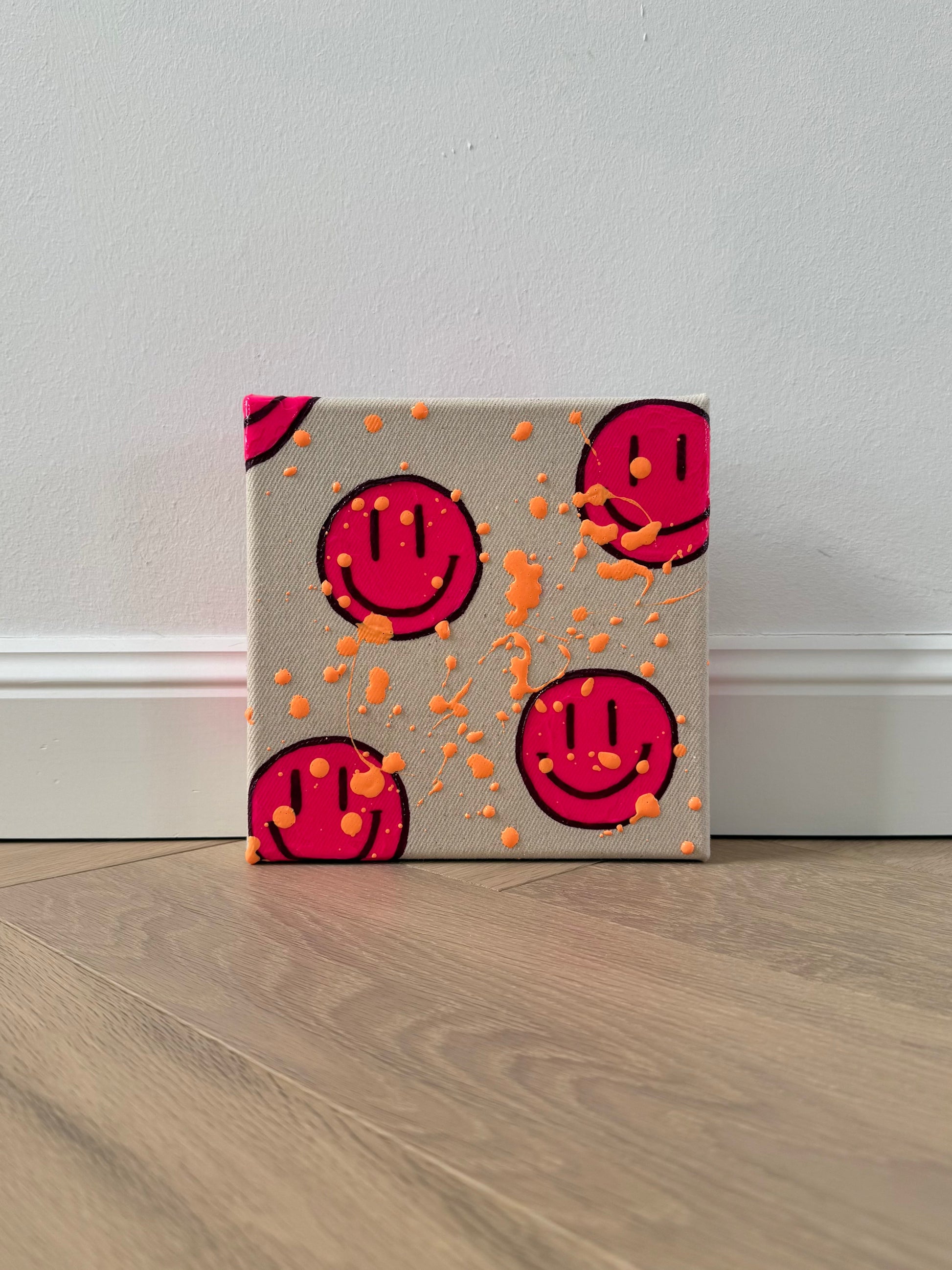 Modernes Happy-Face Kunstwerk „HAPPY #14“ – kleines Acrylbild in Neonpink auf roher Leinwand (20×20 cm) mit apricotfarbenen Farbspritzern, handgemaltes Original