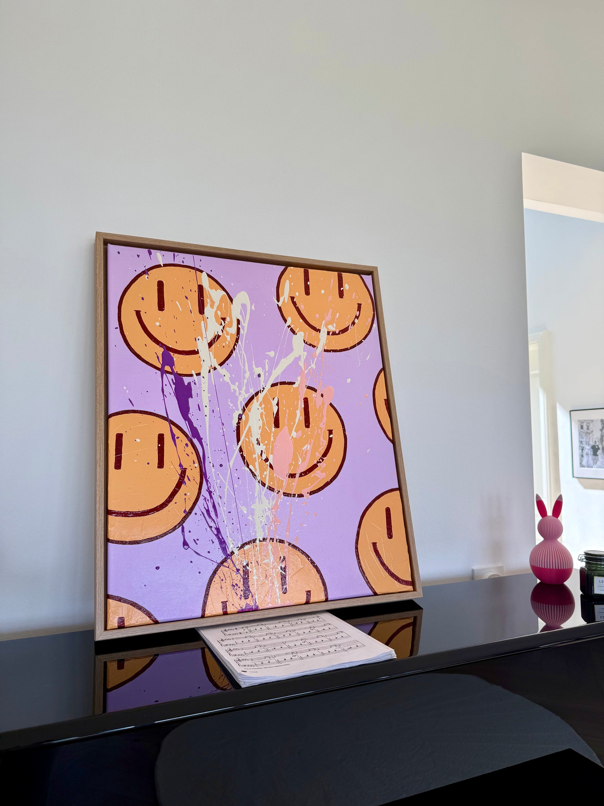 HAPPY #16, handgemaltes Smiley Wandbild auf Leinwand in Wohnraum Umgebung, moderne abstrakte Kunst mit warmen Farbakzenten.