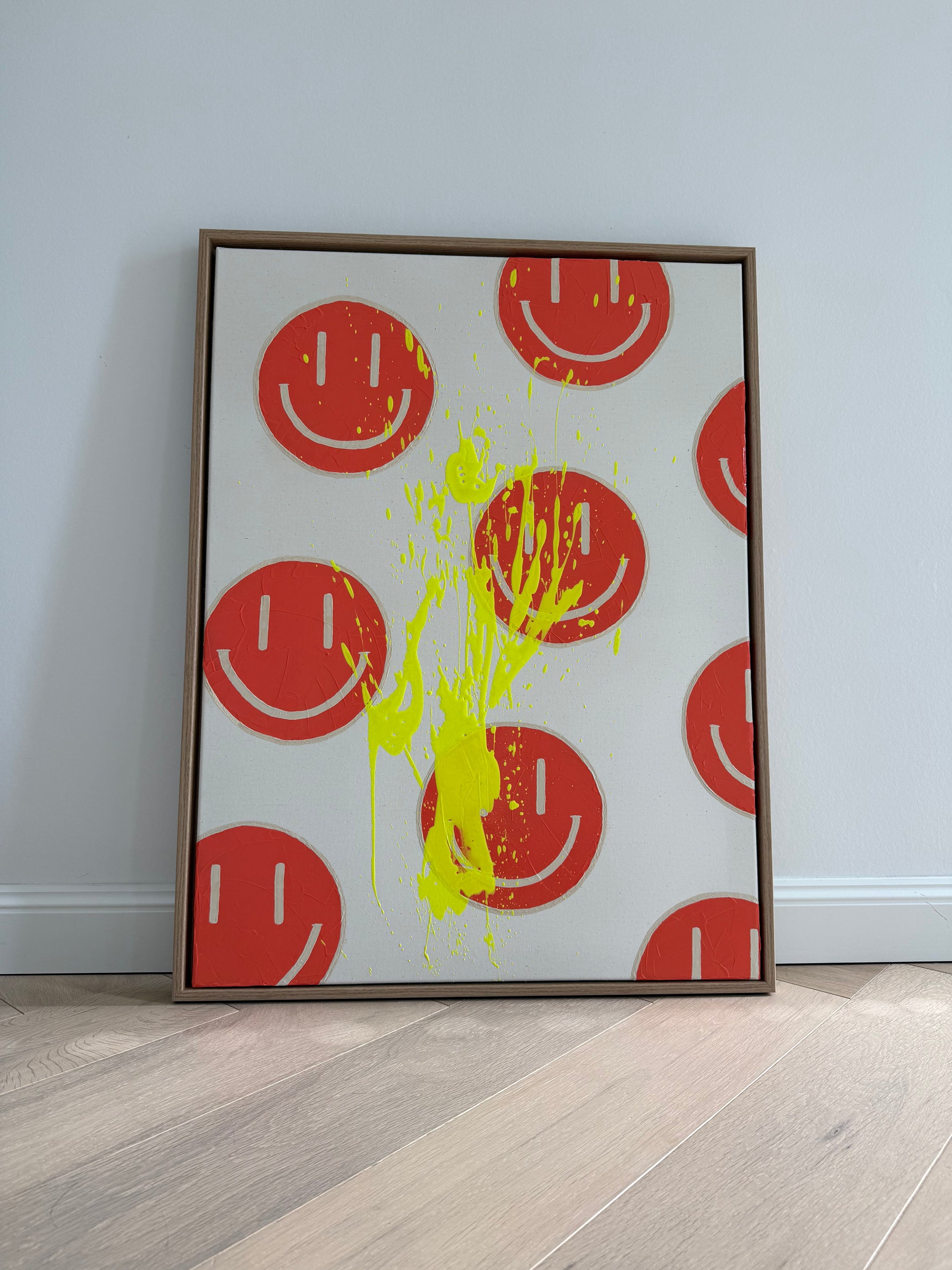 HAPPY #18 frontal fotografiert, abstraktes Pop-Art Acrylbild mit orangenen Happy-Faces und neongelbem Highlight-Spritzer im Eichenrahmen